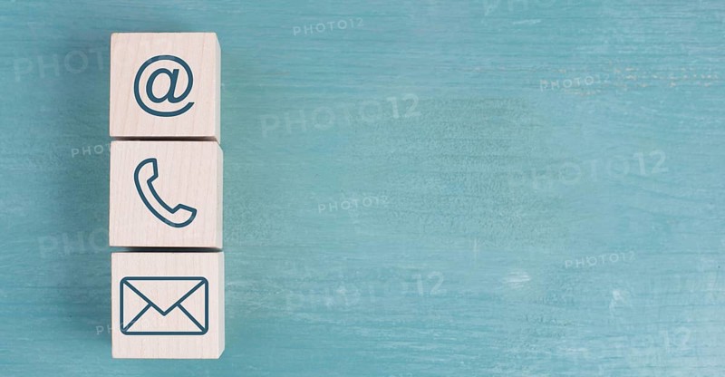 Signs for e-mail, phone and newsletter on wooden blocks, blue background, copy space for text, business support and communication concept