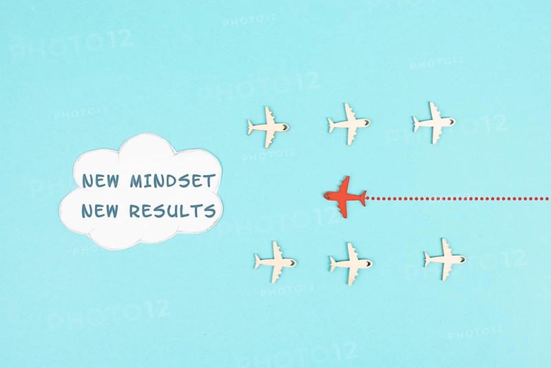 Red airplane is flying to the cloud with the words new mindset new results, changing lifestyle, coaching and improvement concept, positive thinking