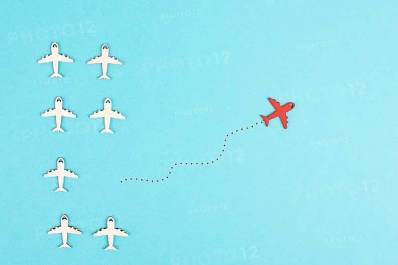Airplanes following the group, red plane thinks different and takes the opposite direction, leadership, courage and winner concept