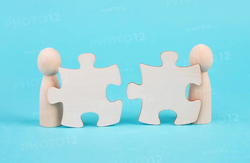 Two men with puzzle pieces built a team, connect the parts together, corporate in teamwork, communication and support concept