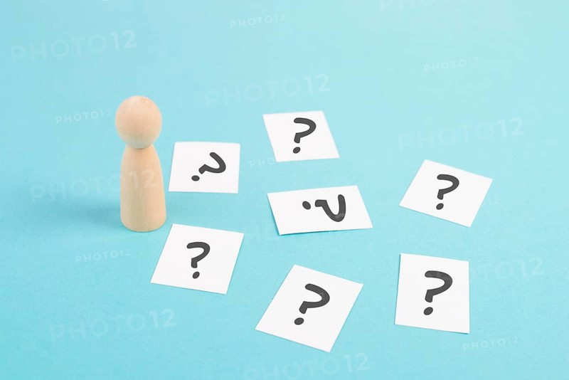 Man is thinking, question marks, brainstorming and looking for answers, solving a problem, making a decision, business and education concept