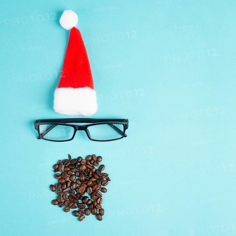 Christmas season, red Santa Claus hat, eyeglasses, beard with coffee beans, funny face, winter time, holiday greeting card, blue background