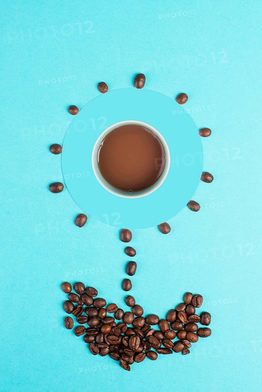 Flower made with coffee beans, espresso standing in the middle, good morning, having caffeine for breakfast, hot drink