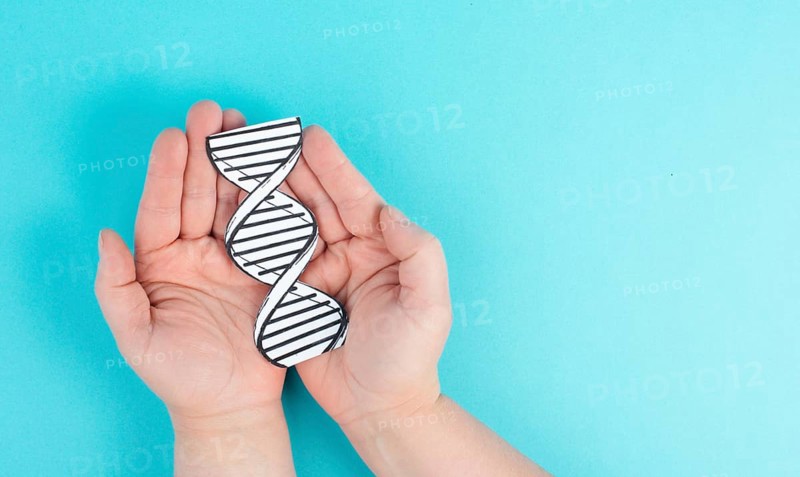 Holding a DNA strand in the hand, genetic therapy and treatment, biotechnology in mordern medicine, gene-based vaccination health care