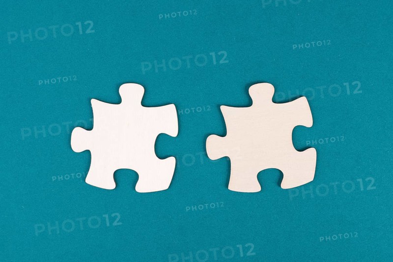 Two pieces of a puzzle, connecting together as a team, solving a problem, strategy and communication concept