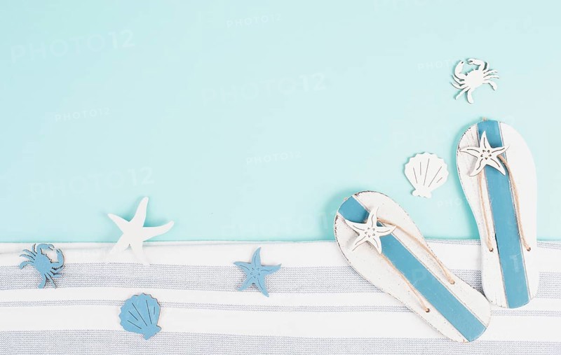 Blue colored summer and holiday background, flip flops, sea stars and fish with copy space, travel and tourism concept