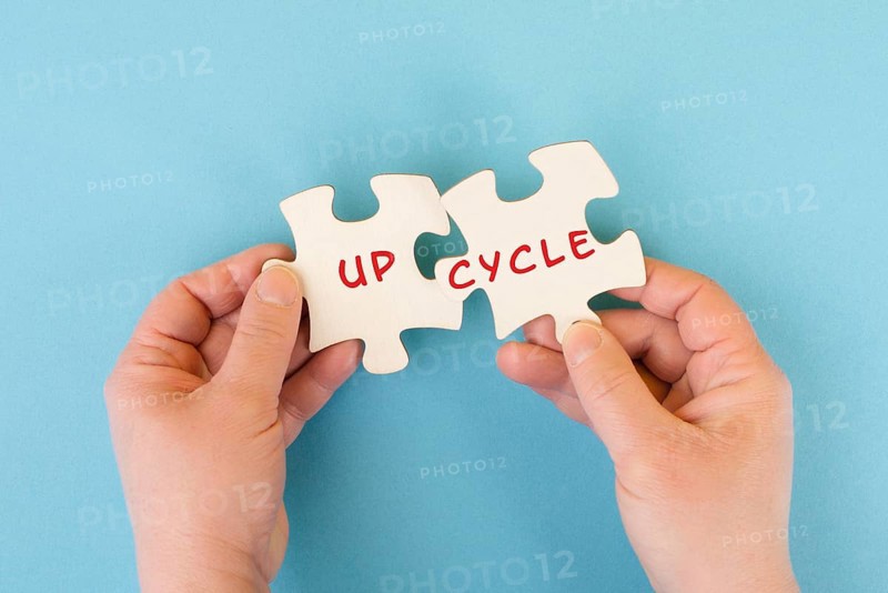 The word up cycle is standing on puzzle pieces, environmental conversation, reuse and repair concept, responsibility with resources, zero waste
