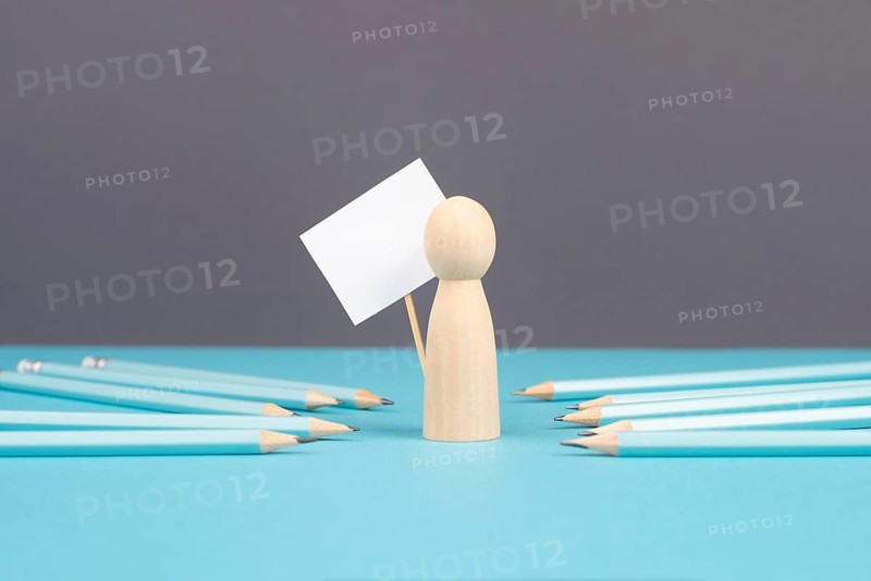Man with an empty sign, blue pencils point to the person, business and education concept, cancel culture and free speech, journalist