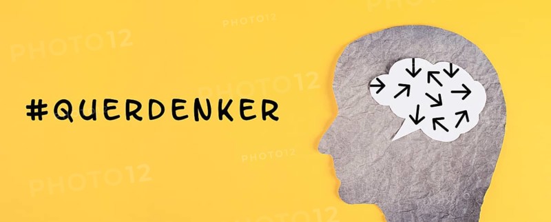 Think different stands in german language on the yellow background, head with brain, being a nonconformist, standing out from the crowd, conspiracy theory