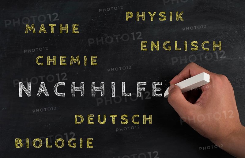 The word for private tutoring is standing in german language on a chalkboard, help for students in maths, physics, chemistry, english and biology, education concept