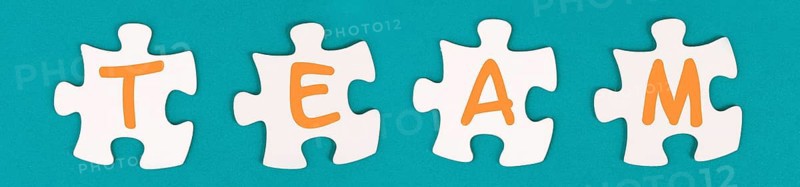 The word team is standing on puzzle pieces, connect the parts together, corporate in teamwork, communication and support concept
