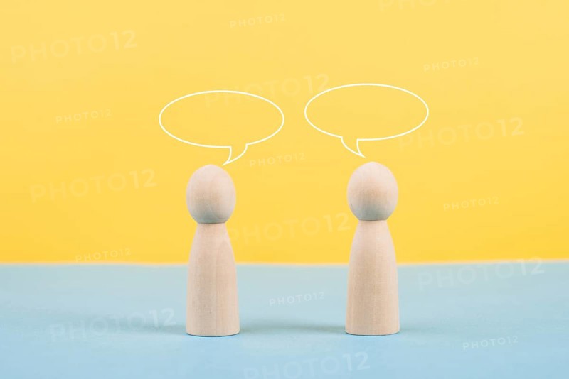 Two people talking together, empty speech bubbles, having a conversation, networking and teamwork concept, social issue