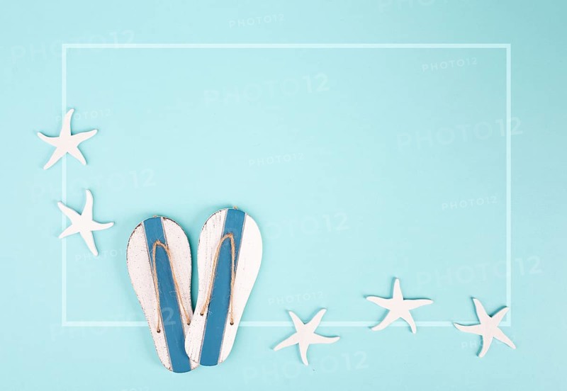 Blue colored summer and vacation background, slippers and sea stars building a frame, copy space for text, holiday and tourism concept