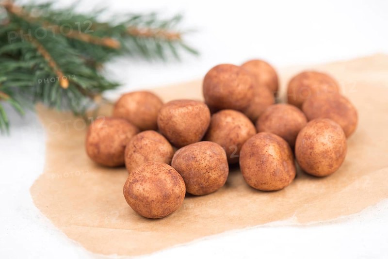 Marzipan potatoes, in german called Marzipankartoffeln, with cacao powder, sweets for christmas, empty copy space