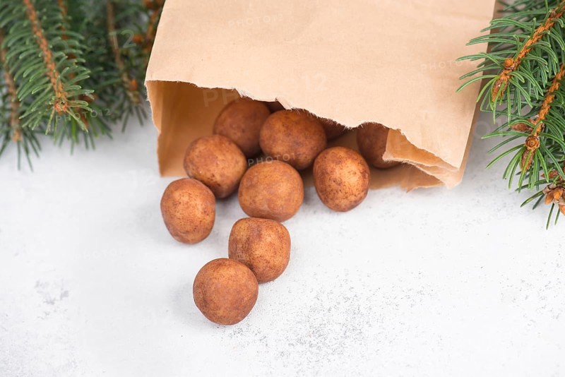 Marzipan potatoes, in german called Marzipankartoffeln, with cacao powder, sweets for christmas, empty copy space