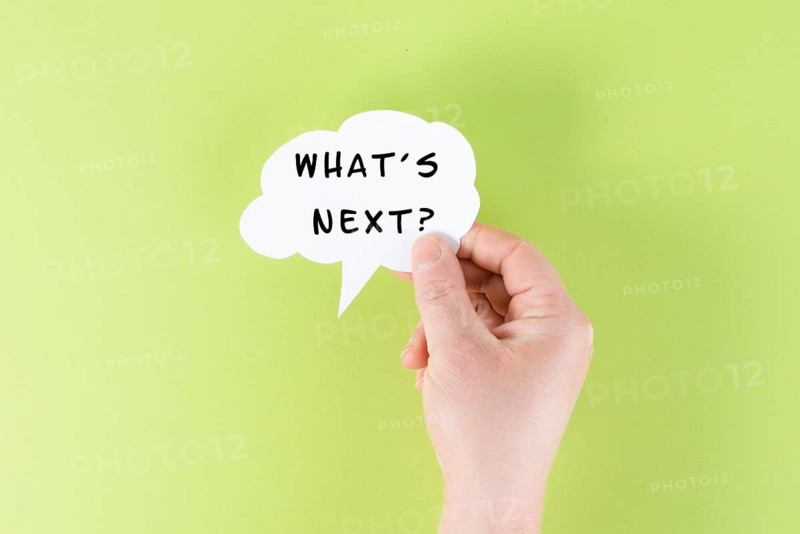 The phrase whatÂ´s next is standing on a cloud shaped paper, having new goals and strategies, making plans for future