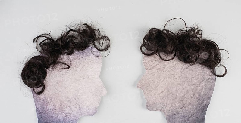 Silhouette of two faces with hair looking to each other, communication, having an opinion and discussion, free speech, people talking