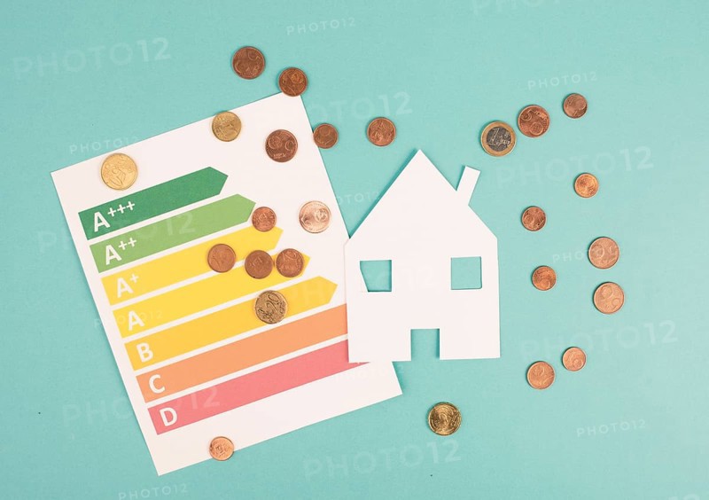 Paper house and Euro coins, power consumption grafic, increasing heating costs, green technology, inflation, social and financial issue