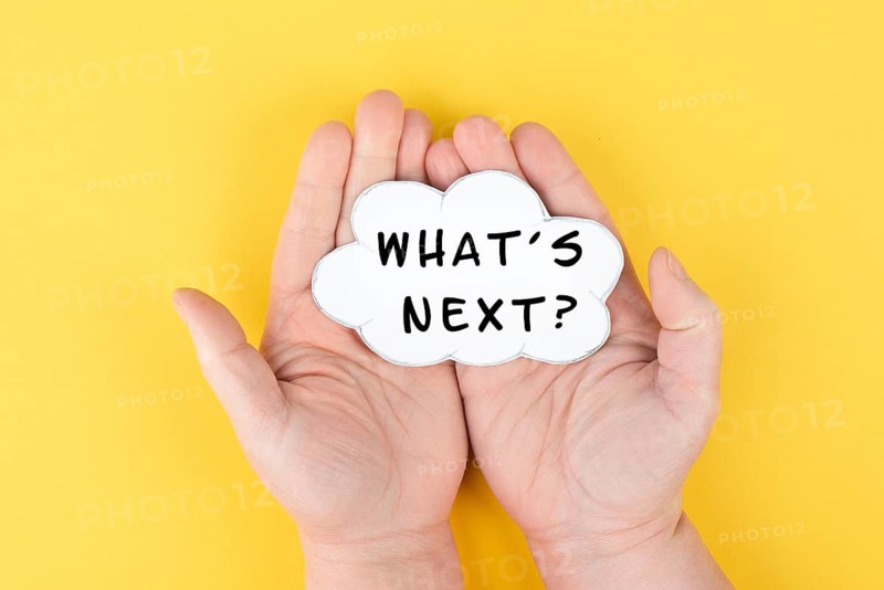 The phrase whatÂ´s next is standing on a cloud shaped paper, having new goals and strategies, making plans for future
