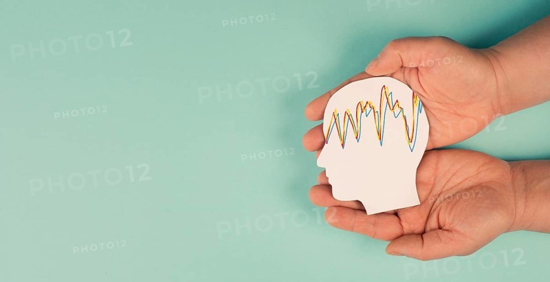 Holding a head in the hands, mental health concept, alzheimer and epilepsy disorder, brain waves, paper cut out