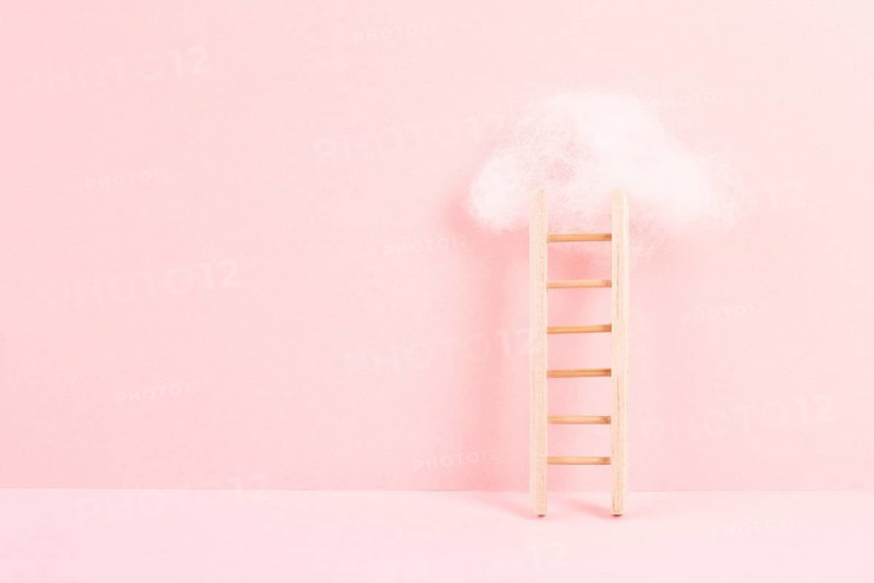 Ladder with a cloud on top, pink rose colored background, copy space, dreaming of success, creative and business concept, achieving new goals