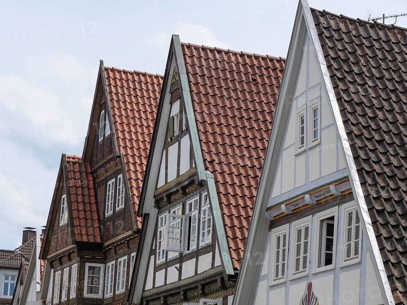 Gables of historic half-timbered houses with red and white roofs under a cloudy sky, Detmold, North Rhine-Westphalia, Germany, Europe