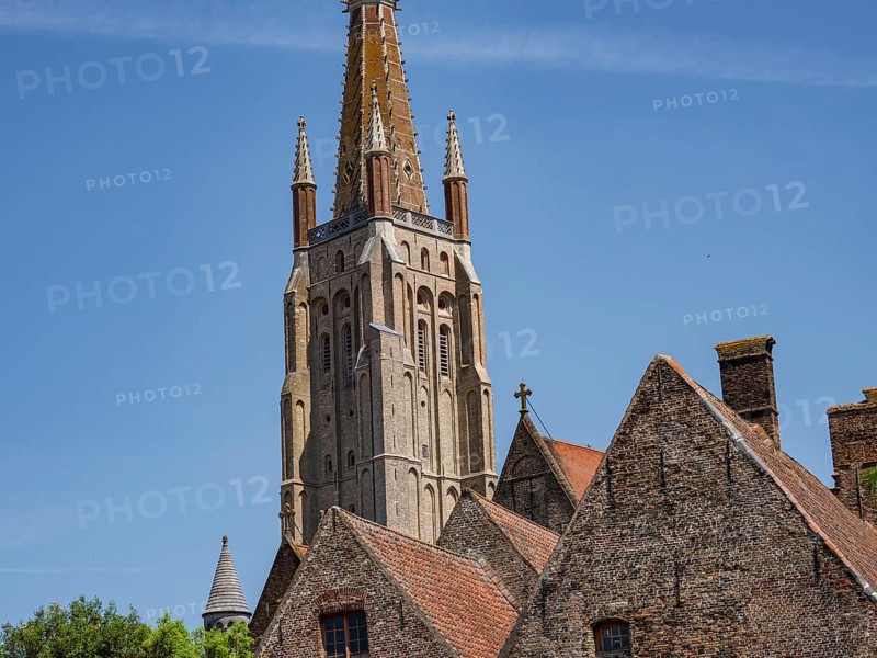 Detailed gothic church and church tower, historic brick buildings in the foreground, Bruges, Flanders, Belgium, Europe