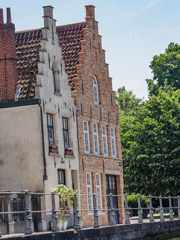 Historic brick houses with gables on a sunny day near a canal, Bruges, Flanders, Belgium, Europe