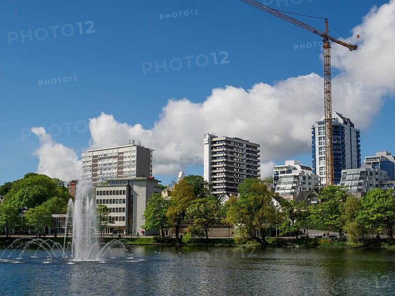 City skyline with a lake and fountain, surrounded by modern buildings and a crane, Stavanger, Norway, Scandinavia, Europe