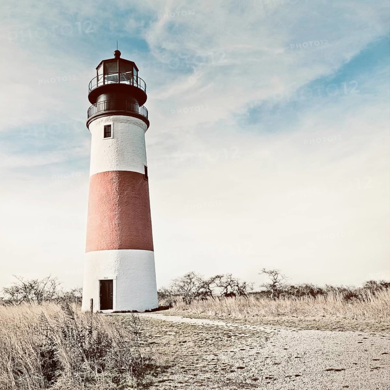 Sankaty Head Light Lighthouse, rendered in a vintage style, Nantucket, Massachusetts USA. The 70 foot tall red and white striped brick lighthouse was built in 1850. It was the first in Massachusetts with a Fresnel lens, replaced in 1950 with a rotating aerobeacon. Although automated in 1965, the Coast Guard occupied the station until 1992. In 2007, it was moved 250 feet from the edge of an eroding bluff to its current location