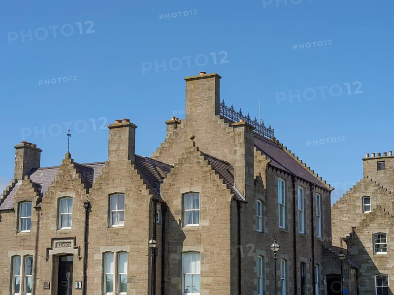 Historic brick buildings with chimneys and windows, shot under a clear blue sky, lerwick, shetlands, scotland, Great Britain