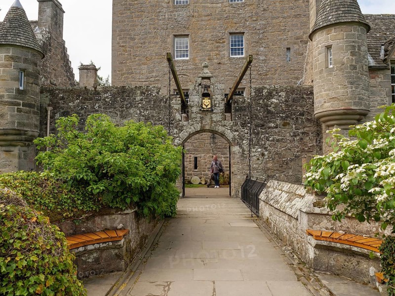 A historic entrance with Tor tor to a castle, flanked by stone walls and benches, inverness, scotland, Great Britain
