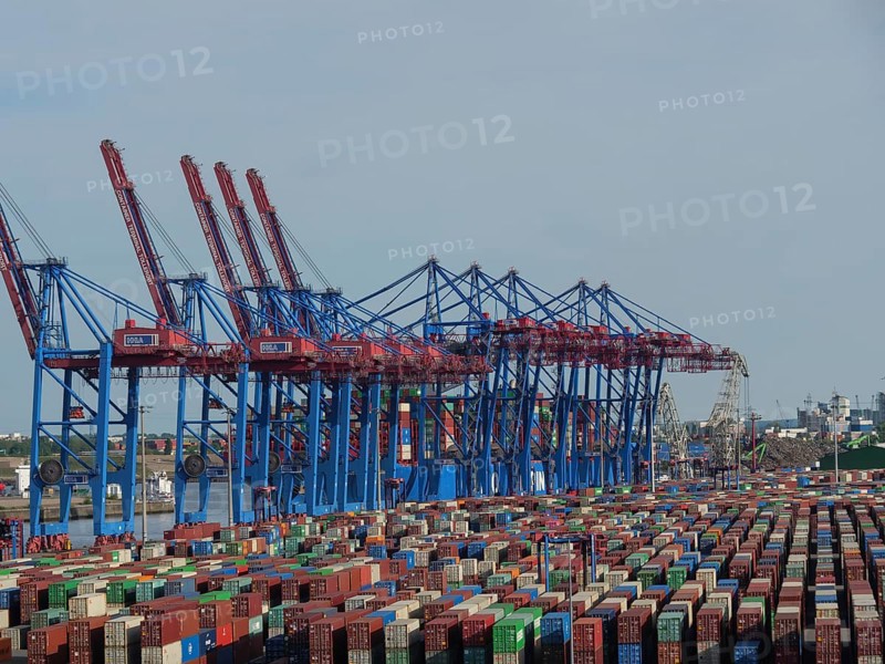 Large container cranes in the harbour, many stacked containers in different colours and ships in the background, Elbe, Hamburg, Northern Germany, Germany, Europe