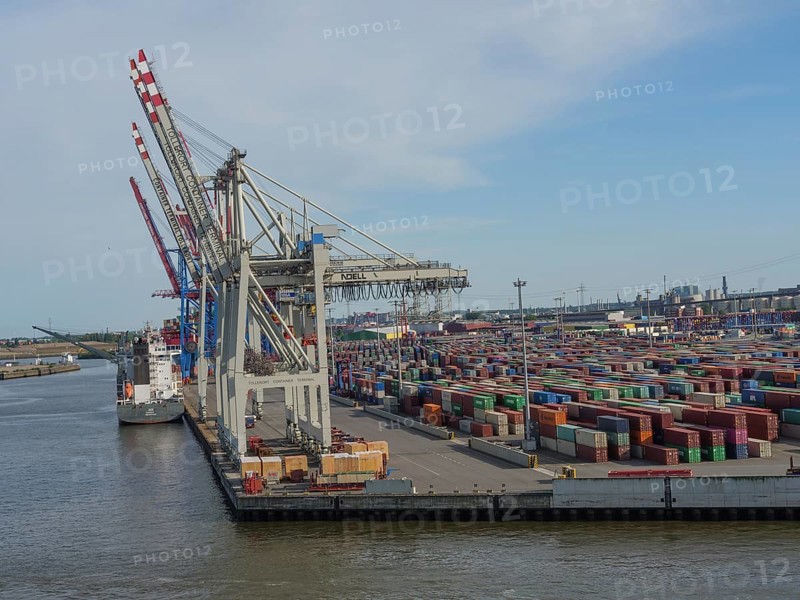 Large cranes in the harbour loading containers, cargo ship at the quay, many containers stacked, Elbe, Hamburg, Northern Germany, Germany, Europe