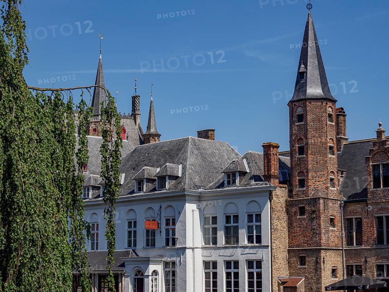 Historic city centre with characteristic architectural towers and brick buildings under a clear sky, Bruges, Flanders, Belgium, Europe
