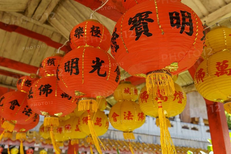 Close-up of several red lanterns with Chinese characters in a traditional temple setting, Pattaya, Thailand, Asia