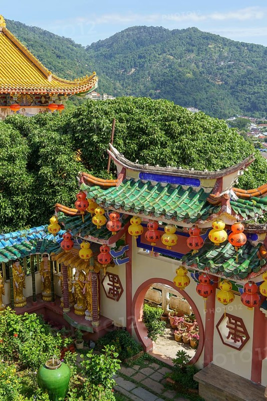 Traditional Chinese architecture surrounded by green mountains and colourful lanterns, Pattaya, Thailand, Asia