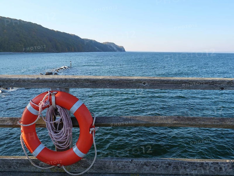 Lifebuoy on a pier with a view of the wide sea and the coast, Binz, Rügen, Germany, Europe