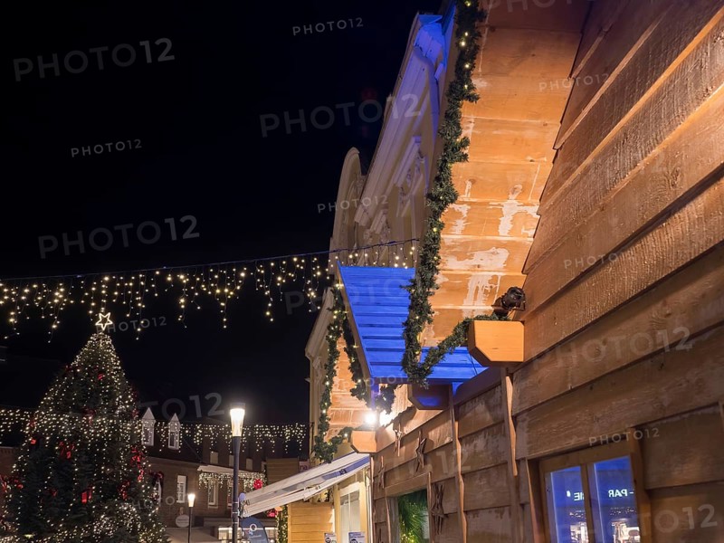 An atmospheric Christmas market at night, with illuminated wooden houses and Christmas decorations, Ahaus, Münsterland, North Rhine-Westphalia, Germany, Europe