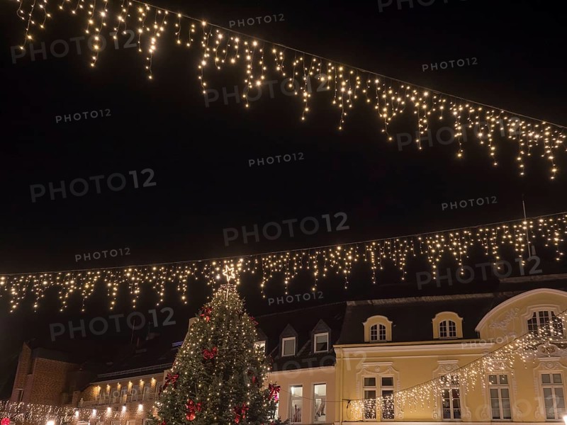 View of a festively illuminated street with fairy lights and a large Christmas tree, Ahaus, Münsterland, North Rhine-Westphalia, Germany, Europe