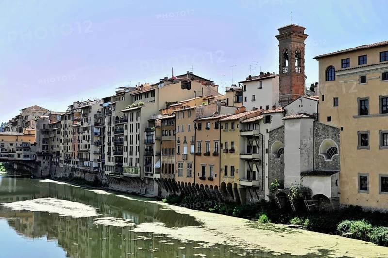 Buildings along the river Arno with bridge Ponte Vecchio, Florence, Tuscany, Italy, Europe, Historic buildings on the river bank in a Tuscan town with calm water and reflections, Europe