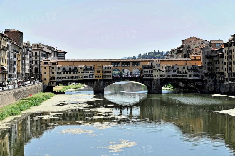 Buildings along the river Arno with bridge Ponte Vecchio, Florence, Tuscany, Italy, Europe, A historic bridge spans a river, surrounded by old buildings, Europe