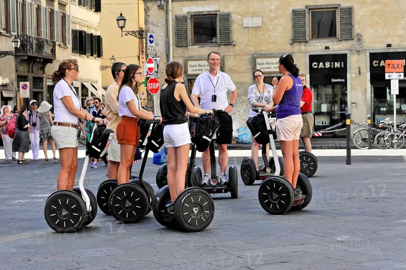 Florence, Tuscany, Italy, Europe, A group of people on Segways on a city tour on a sunny day, Europe