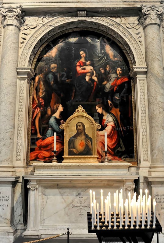 Interior, Cathedral of Santa Maria Assunta, Pisa, Tuscany, Italy, Europe, Altarpiece in a church shrine shows holy figures and is framed by candles, Europe