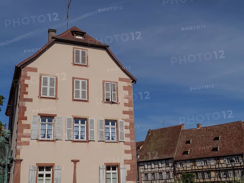 Historic building in an old town centre with white and blue shutters and half-timbered details under a clear sky, Wissembourg, Alsace, France, Europe