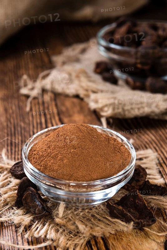 Milled Cola Nut (close-up shot) on rustic wooden background