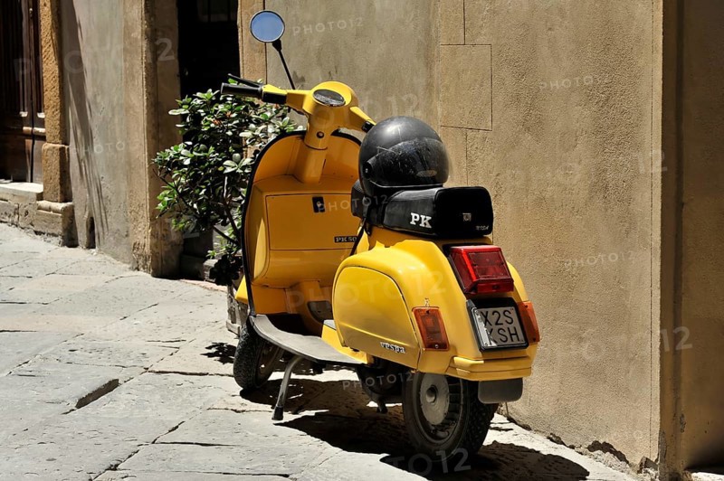 Pienza, Val d'Orcia, Orcia Valley, UNESCO World Heritage Site, Province of Siena, Tuscany, Italy, Europe, Yellow Vespa scooter with black helmet, parked in a narrow alley in the historic centre with scattered plants, Tuscany, Europe Italy, Europe