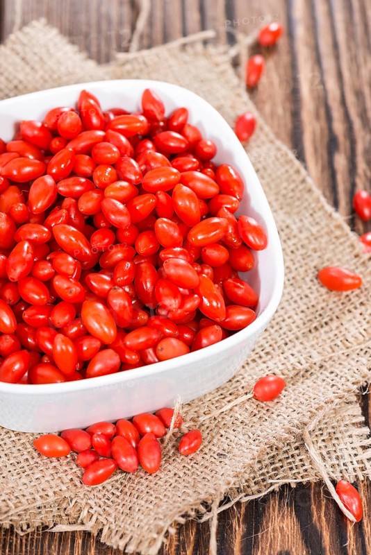 Some fresh Goji Berries (also known as Wolfberry) on vintage wooden background
