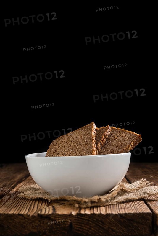 Slices of Brown Bread (selective focus) on an old wooden table