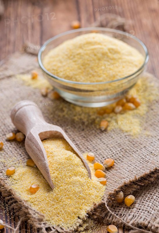Portion of Cornmeal (on rustic background) as detailed close-up shot